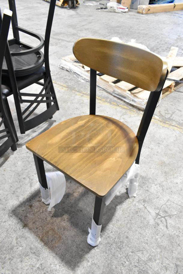 Brand new Lancaster Table & Seating black metal dining chair with wooden back and seat, scratch and dent condition.
