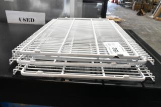Lot of 4 white poly-coated racks, used condition, minor wear visible, stackable design, tagged "192."