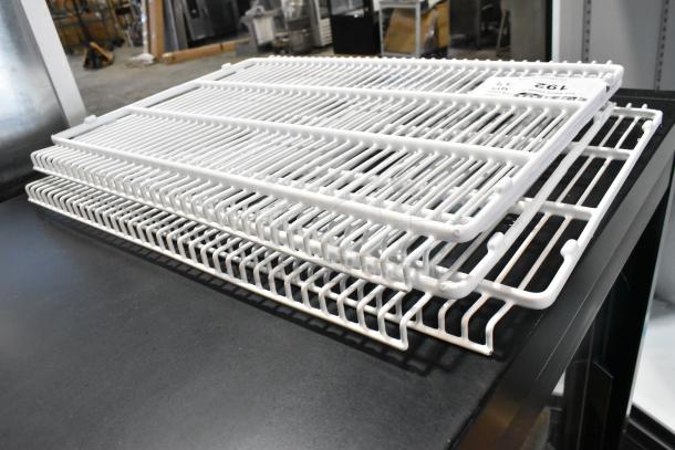 Lot of 4 white poly coated racks in excellent condition with visible Z6L label indicating rack model.