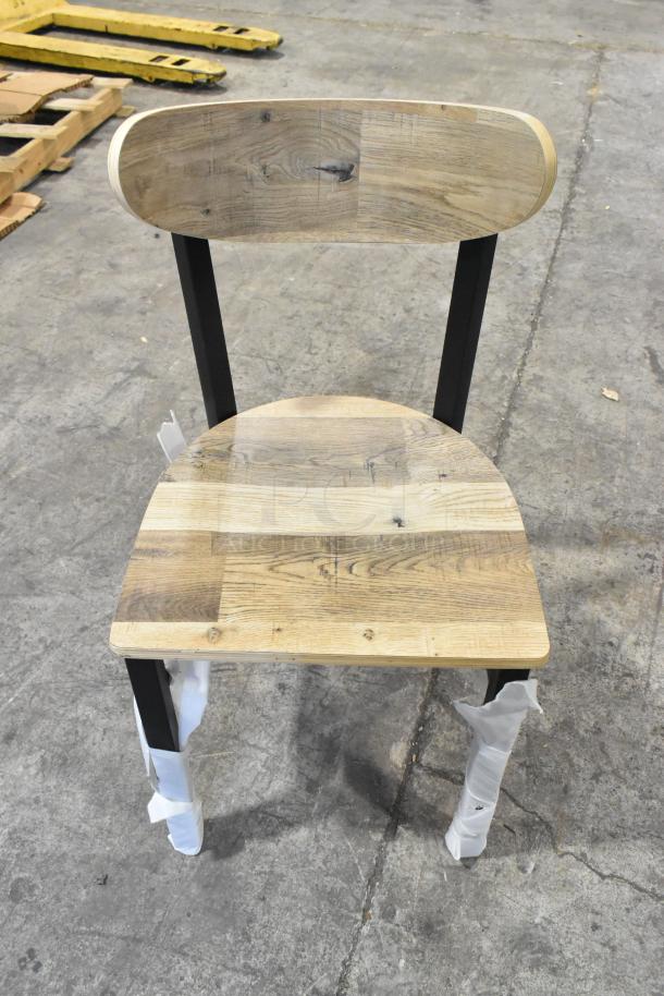 Lancaster Table & Seating black metal chair with wooden backrest and seat, scratch and dent condition, new, dining height.