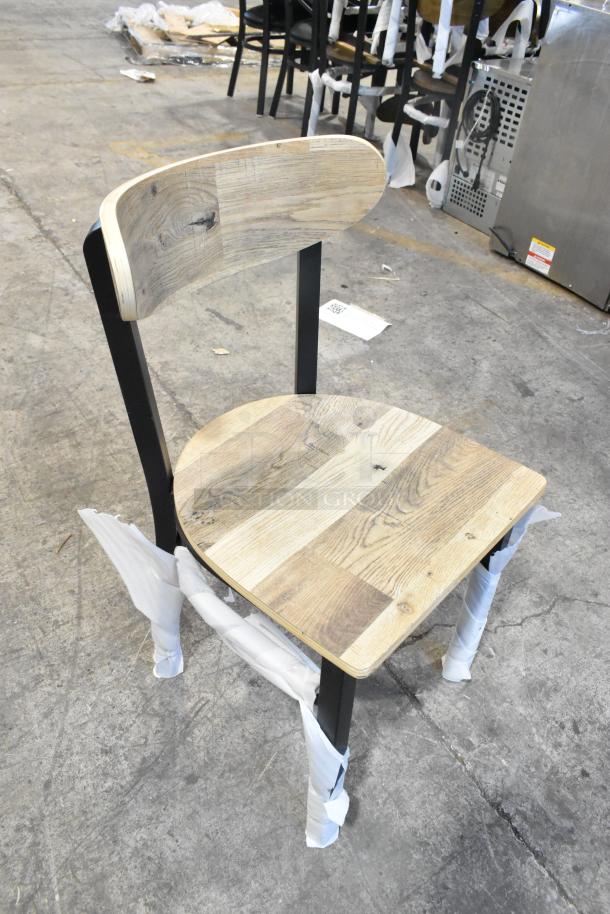 Lancaster Table & Seating black metal chair, wooden back and seat, dining height, brand new, scratch and dent, protective wrapping.