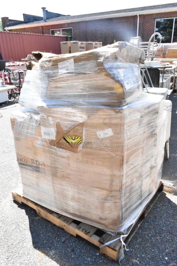 Pallet of scratch and dent items wrapped in plastic, including white paper bags, carpet extractor, and beverage dispenser.