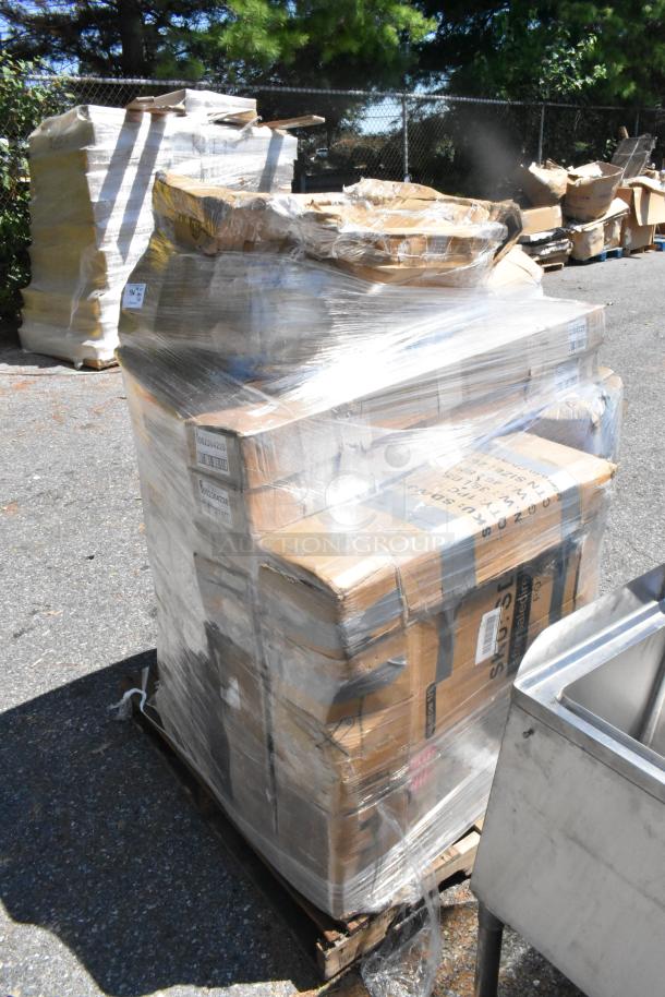 Pallet wrapped in plastic containing boxed auction items, including shopping bags, carpet extractor, and beverage dispenser.
