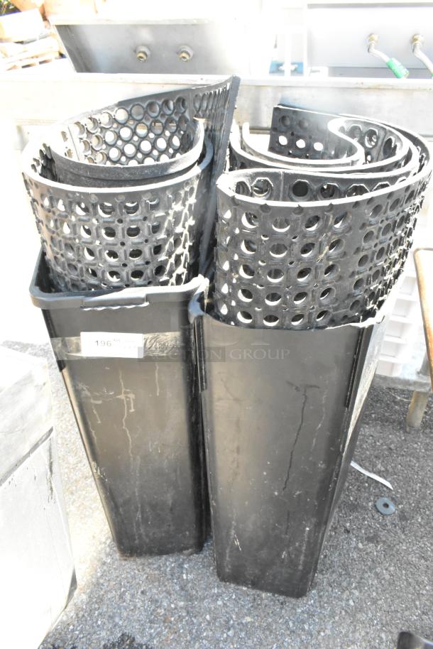 4 black anti-fatigue floor mats and 2 black Poly Slim Jim trash cans. Visible wear, numbered tag 196.