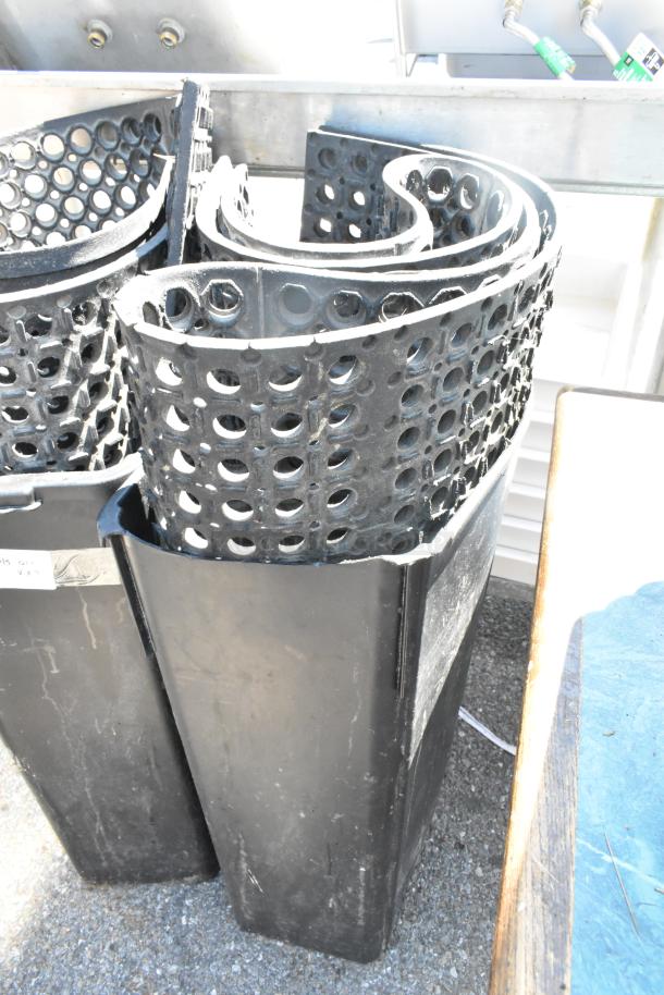 Two black anti-fatigue mats with circular holes and two black Slim Jim trash cans, good condition.