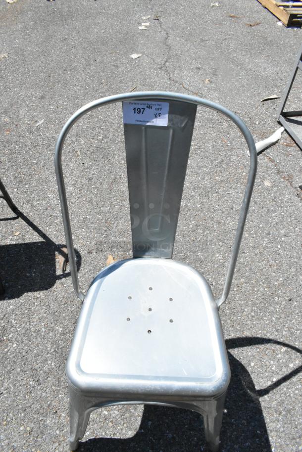 Metal Tolix style dining chair, silver finish, metal construction, sturdy design, visible tag indicating quantity of 5.