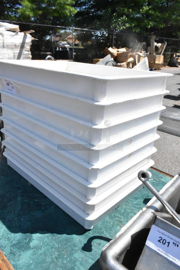 Stack of 8 white poly dough bins in good condition. Auction tag visible, labeled "199" and "201".