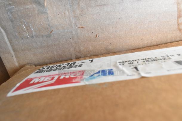 10 brand new scratch and dent boxes with Metro 3036NC, 1236BK, 1830NC shelves, and SWK36-1 Smartwall. Visible Metro label.