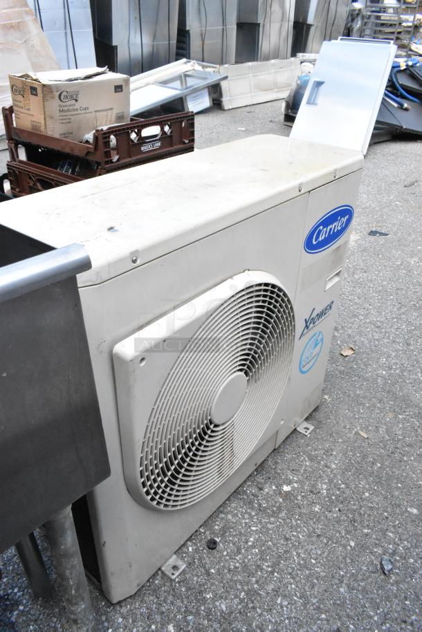 Carrier Xpower Air Conditioning Inverter, good condition, visible Carrier and Xpower logos, outdoor unit seen.