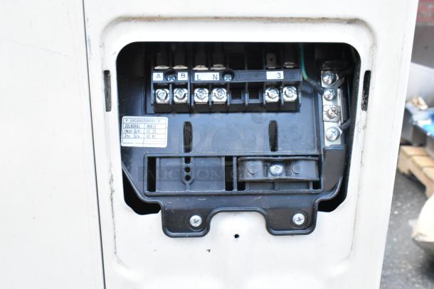 Carrier Xpower air conditioning inverter with exposed wiring panel. Label shows model V-28DDB850000-R and software versions.