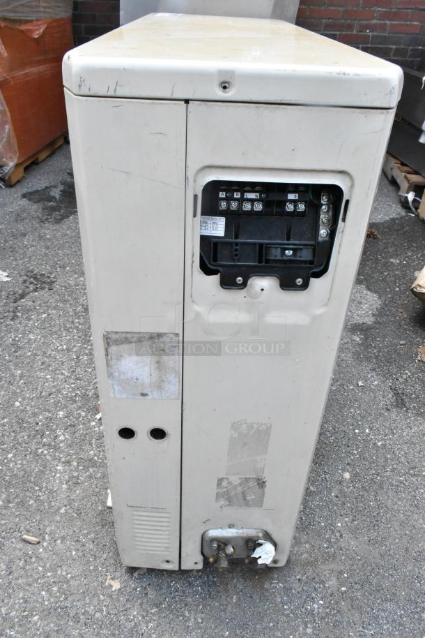 Carrier Xpower air conditioning inverter, worn exterior, visible wiring panel, signs of use, potential for parts or refurbishing.