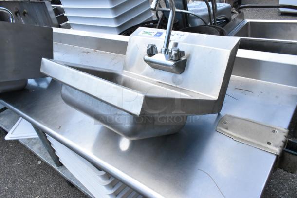 Regency stainless steel wall mount sink with faucet and handles, single bay, durable, slight wear visible, ideal for commercial use.