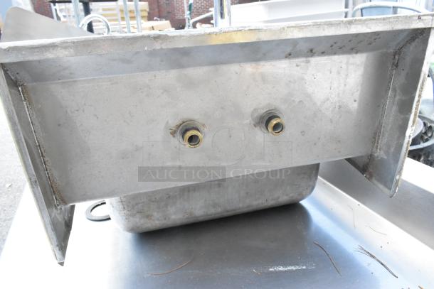 Regency stainless steel wall mount sink, single bay, shown with faucet and handles, visible wear, mounting hardware visible.