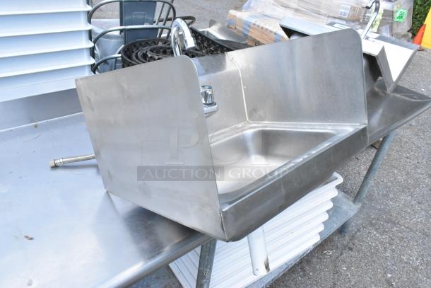 Yukon stainless steel wall mount sink with faucet, handles, and side splash guards. Single bay, gently used condition.