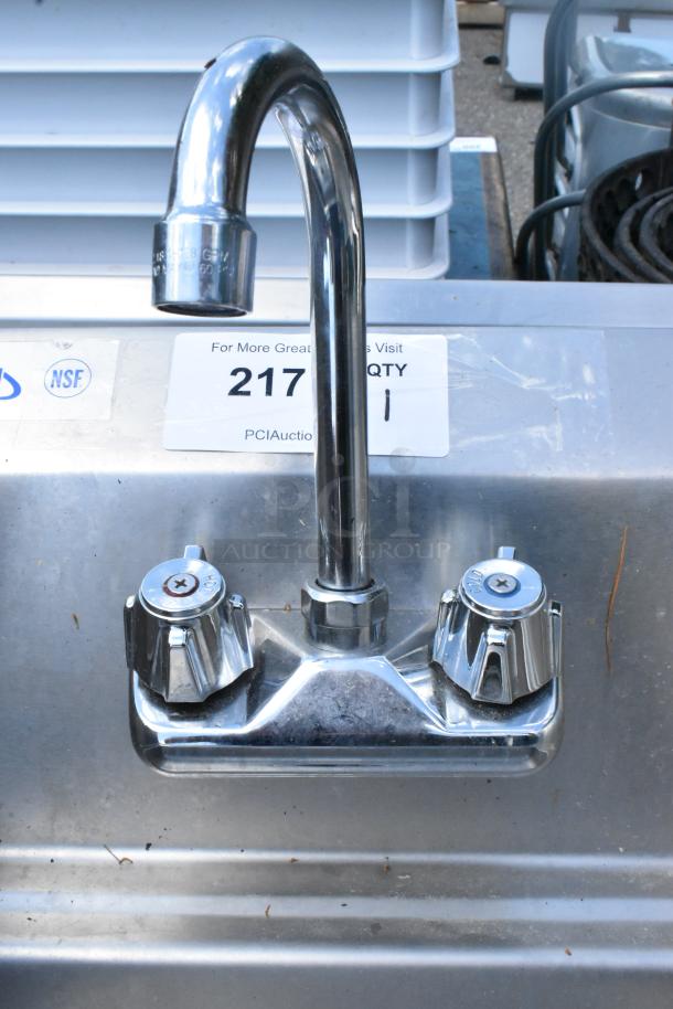 Yukon stainless steel wall mount sink with side splash guards, faucet, and handles. Features NSF label.