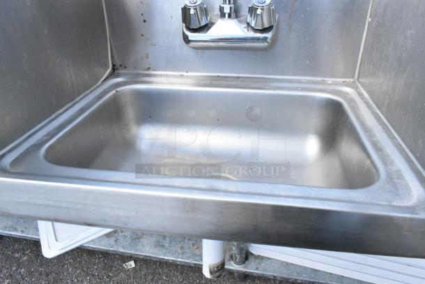 Yukon stainless steel wall mount sink with side splash guards, faucet, and handles. Single bay, moderate wear.