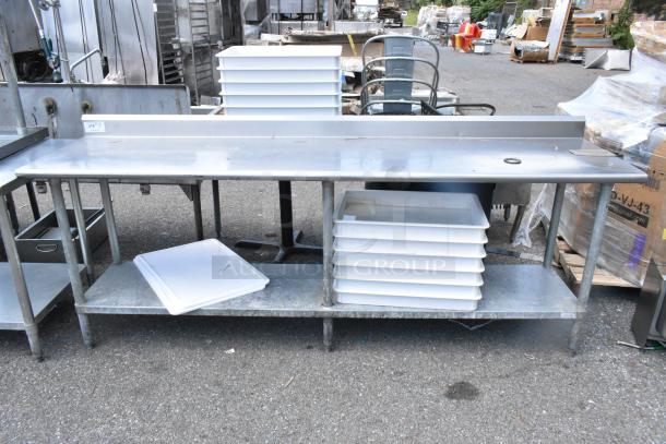 Stainless steel table with metal under shelf, includes multiple white dough bins, in outdoor setting.