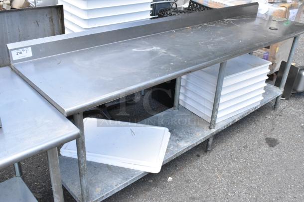 Stainless steel table with metal under shelf, stacked with dough bins, in used condition, item tag visible.