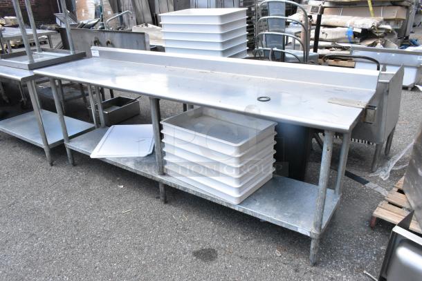Stainless steel table with metal under shelf and stacked dough bins, suitable for kitchen use. Sturdy, used condition.