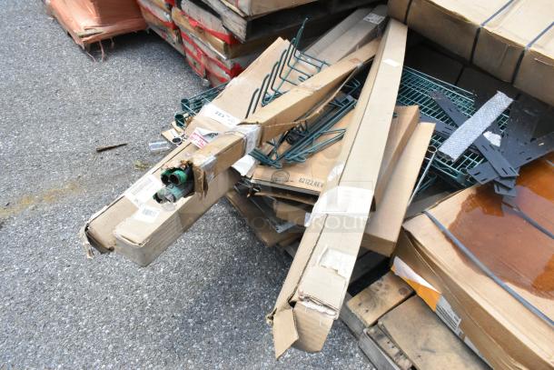 Pallet with various brand new scratch and dent items, featuring Metro SWS18K3 green wire shelves, in original packaging.