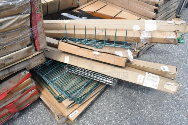Pallet of new scratch and dent items featuring Metro SWS18K3 shelf and green wire shelves, boxed, some wear.