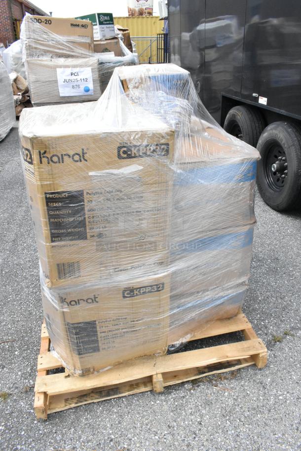 Plastic-wrapped pallet with Karat boxes containing new scratch and dent paper towel rolls, lids, and cups. Labels show item details.