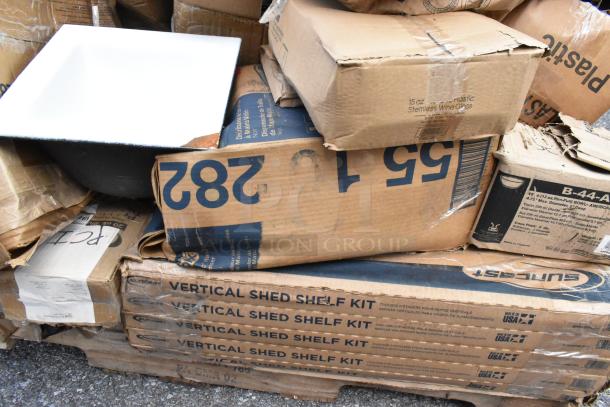 Pile of boxes with visible labels, including SunCast Vertical Shed Shelf Kit. Contents include new scratch and dent items.
