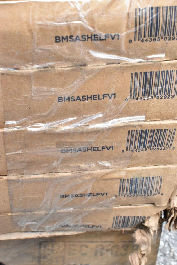 Cardboard boxes labeled "BMSASHELFV1" with visible barcodes. Items include shelf kit, aluminum trays, stock pot. Condition: scratch and dent.