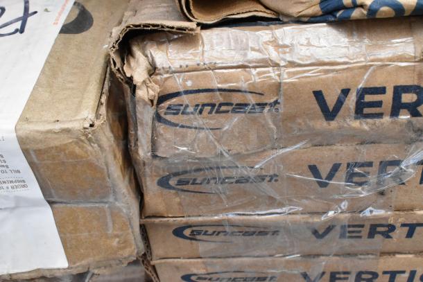 Boxes labeled "Suncast" indicate brand new items, potentially including a shelf kit and aluminum trays; visible cardboard damage.