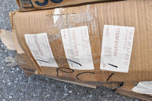 Cardboard box labeled "Tray Seafood" with various item codes; contains new scratch and dent items like aluminum trays.