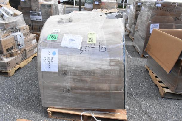 Plastic-wrapped booth on pallet labeled "BRAND NEW SCRATCH AND DENT," showing various handling labels and markings like "304 lb."