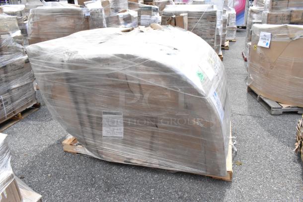 "Brand new booth wrapped in plastic, labeled as 'scratch and dent,' on a wooden pallet, outdoor setting."