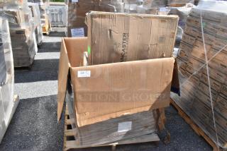 Cardboard box labeled "Lancaster Table & Seating" on a pallet, showing signs of damage and wrapped in plastic.