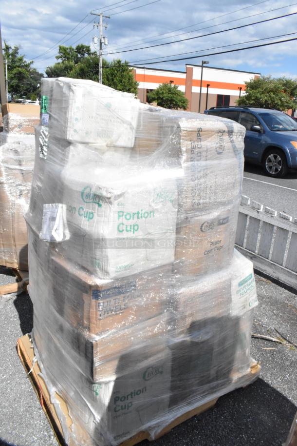 Pallet of brand new scratch and dent items, including portion cups, takeout containers, cold cups, steam table pan lids, wrapped in plastic.