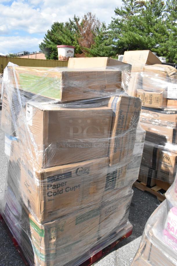 Pallet of boxes wrapped in plastic, labeled with paper cold cups and other kitchen supplies. Auction includes various new items.