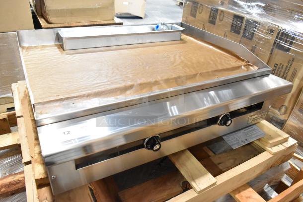 Brand new Therma-Tek TC36-36TGL stainless steel propane flat top griddle on a pallet. Unused, still in box.