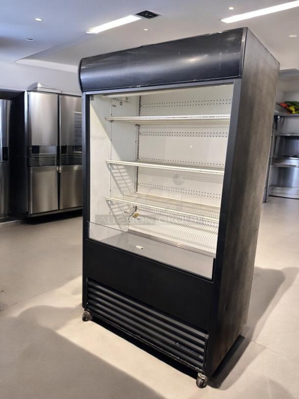 True TAC-48 air curtain merchandiser in excellent condition, 208/230V, fully tested, black exterior, multiple shelves.
