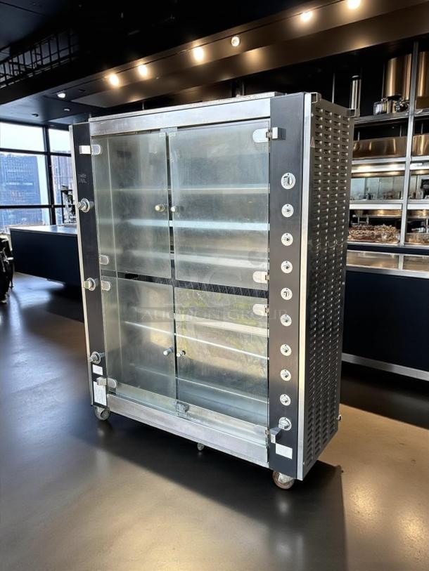 Industrial stainless steel oven on wheels with glass doors, featuring multiple dials on the side. Appears in good condition.