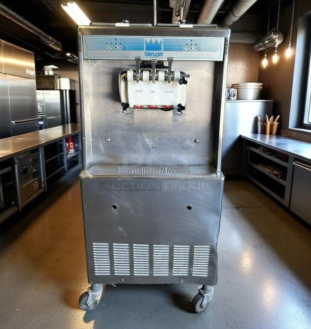 Taylor commercial soft serve machine, model 138, in used condition. Features three flavor options and stainless steel exterior.