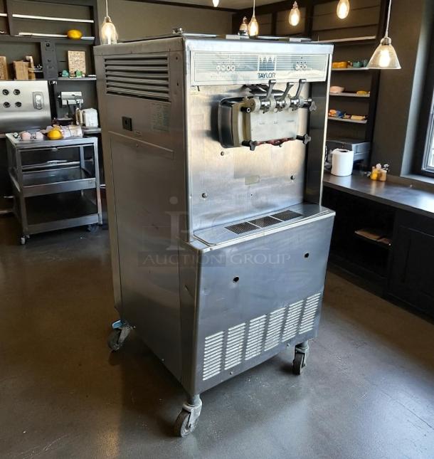 Taylor ice cream machine on wheels, stainless steel, model 138, commercial use, visible control panel, good condition.