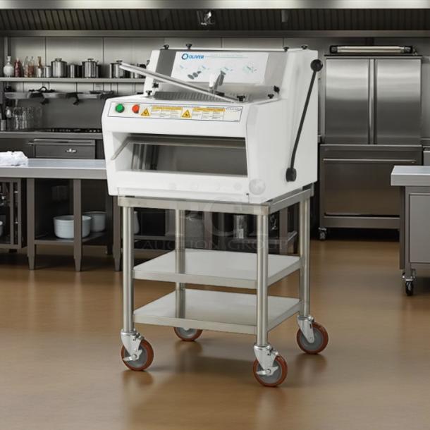 Oliver bread slicer model 139, white, on stainless steel table with wheels. Visible control buttons and warning labels. Ideal for bakeries.