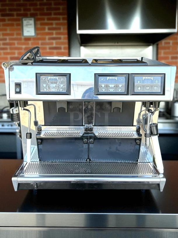 Commercial espresso machine with dual spouts, digital controls, and stainless steel finish. Excellent condition. Model 141.