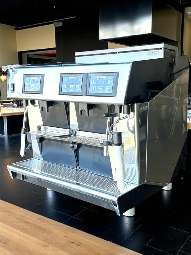 Commercial espresso machine, stainless steel, dual group heads, digital controls, steam wands, good condition.