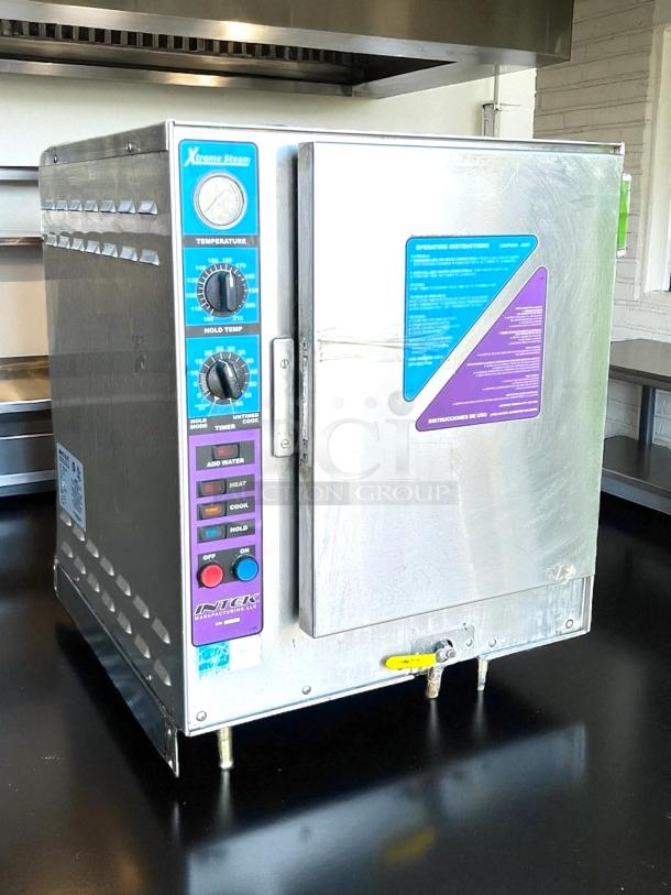 Intek Xtreme Steam oven, model 142. Stainless steel with dial controls. Visible instructions and branding on the side. Good condition.