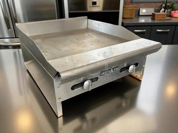 American Range griddle, stainless steel, dual controls, gently used. Logo on front, commercial kitchen setting.