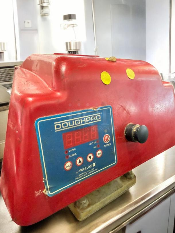DoughPro ProLuxe Pizza Dough Press, excellent condition, heated platens, 120V, digital control panel, fully tested.