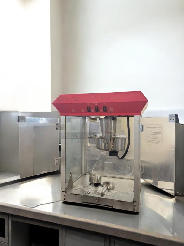 Commercial Grade Countertop Popcorn Maker, excellent condition, 120V, fully tested. Features red top and stainless steel components.
