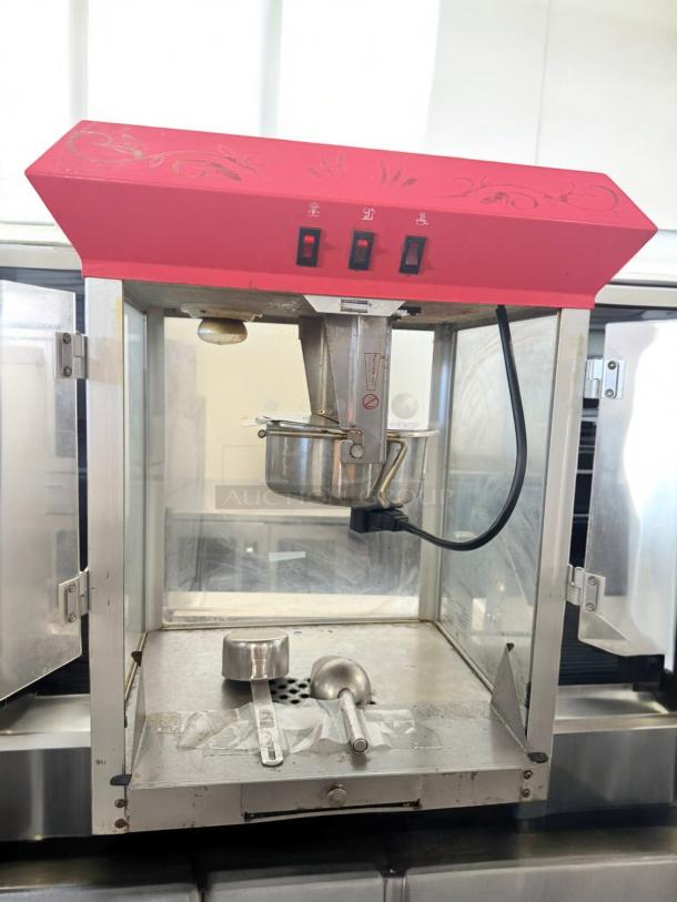 Commercial Grade countertop popcorn machine, excellent condition, 120V, fully tested. Features visible switches, clean interior.