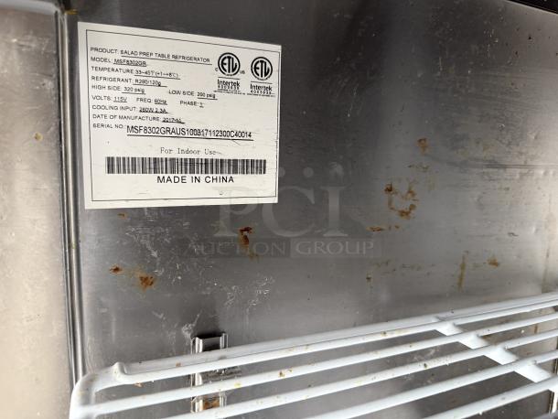 Label showing Atosa MSF8302GR Sandwich/Salad Prep Table specs, including temperature range, voltage, and refrigerant type.