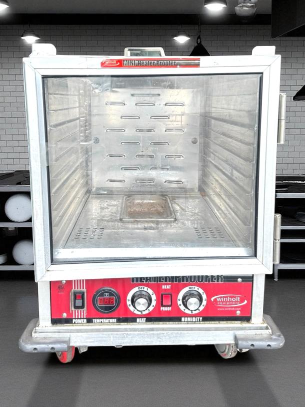 Win-Holt Model NHPL-1810/HN-CA/LC non-insulated heater/proofer cabinet, perfect condition, clear door, control panel with dials.